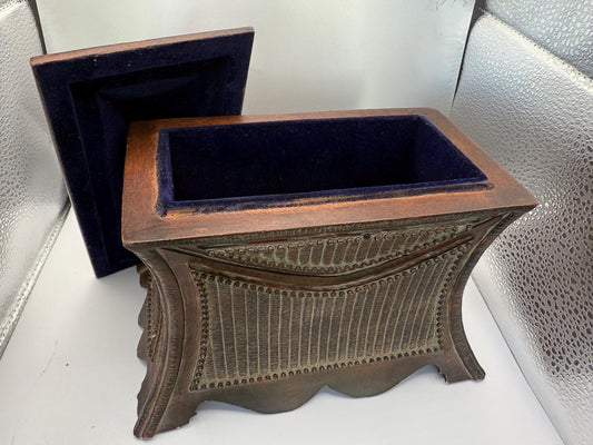 A vintage wooden oriental style jewelry box with suede lined inside interior