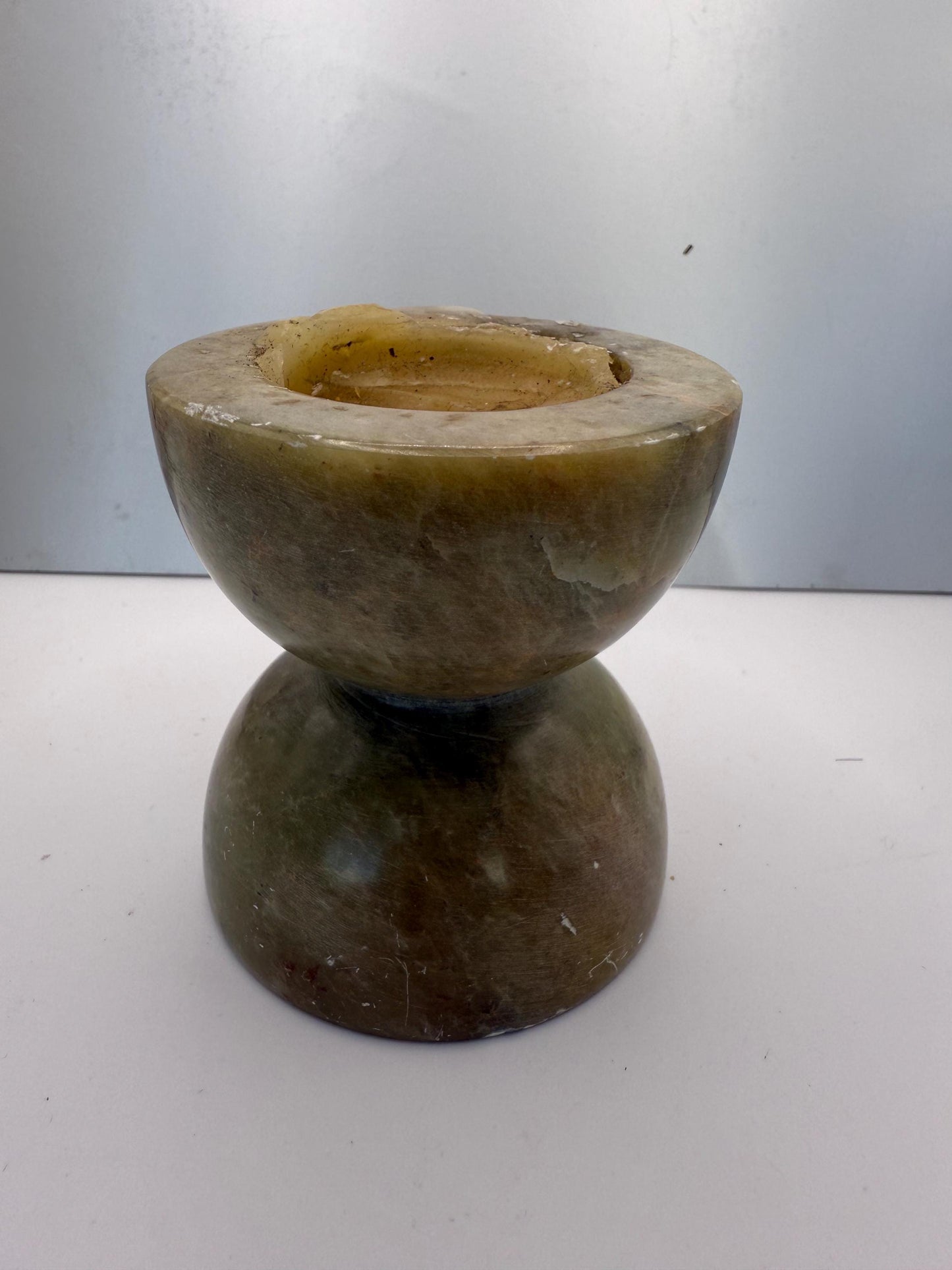 A green soap stone candle holder hand made in India