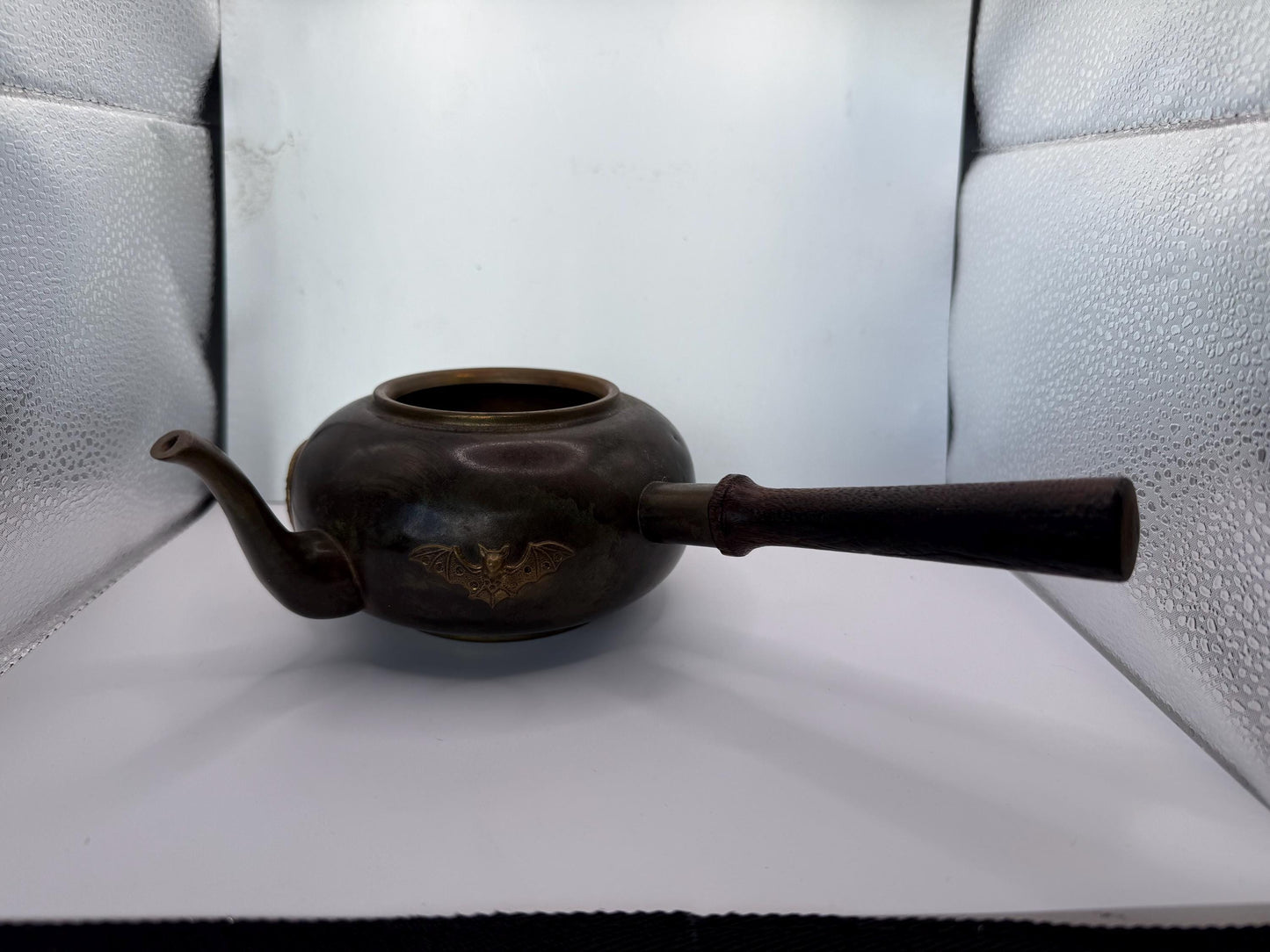 A cooper bronze vintage tea kettle with bats and moons wooden handle