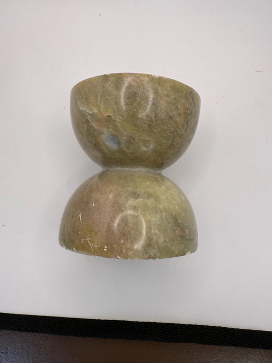 A green soap stone candle holder hand made in India