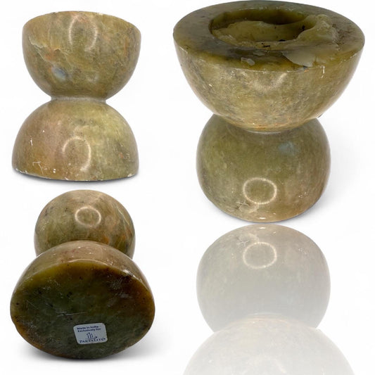 A green soap stone candle holder hand made in India
