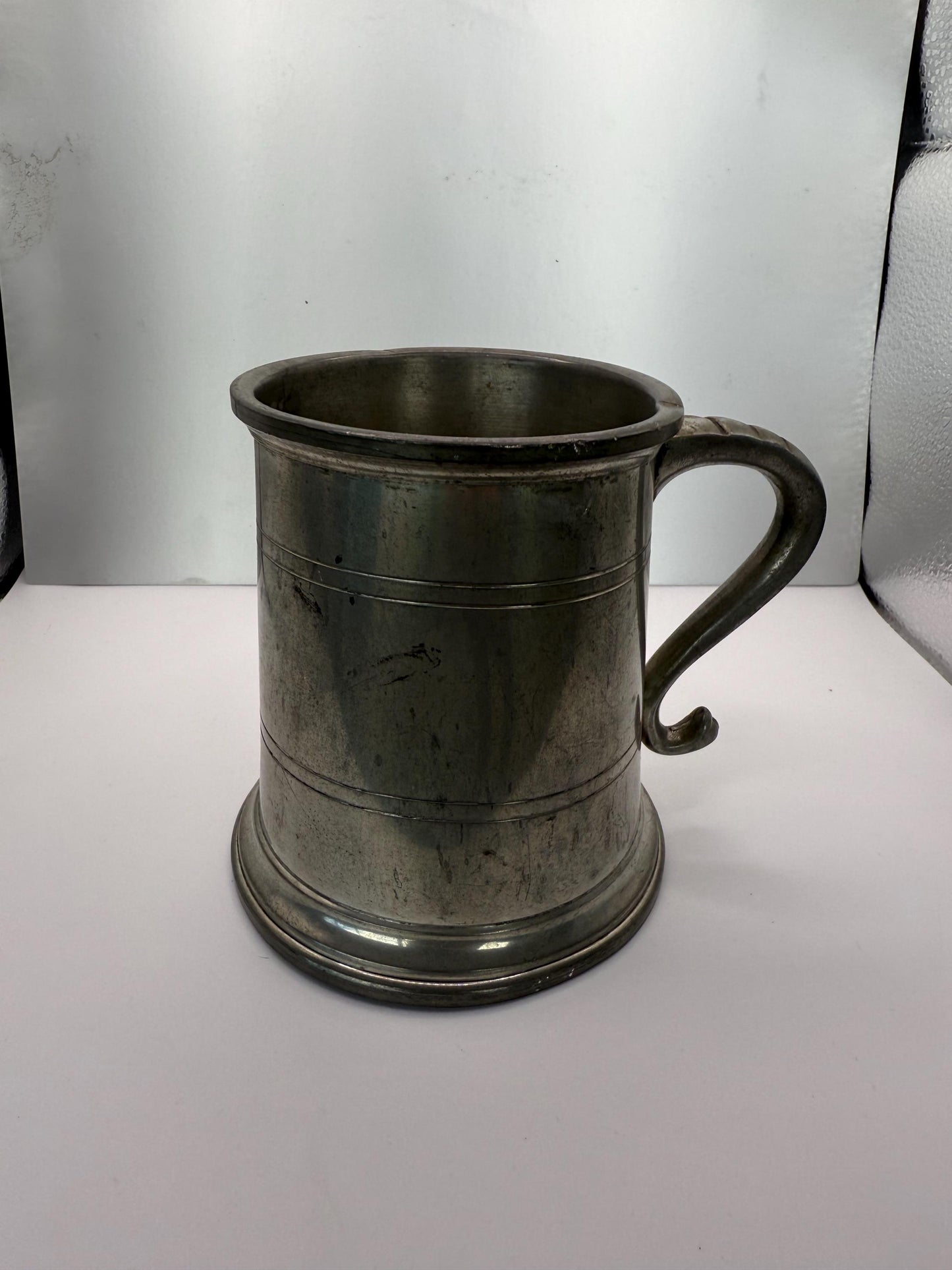 A vintage solid pewter pint cup with handle 19th century American mug