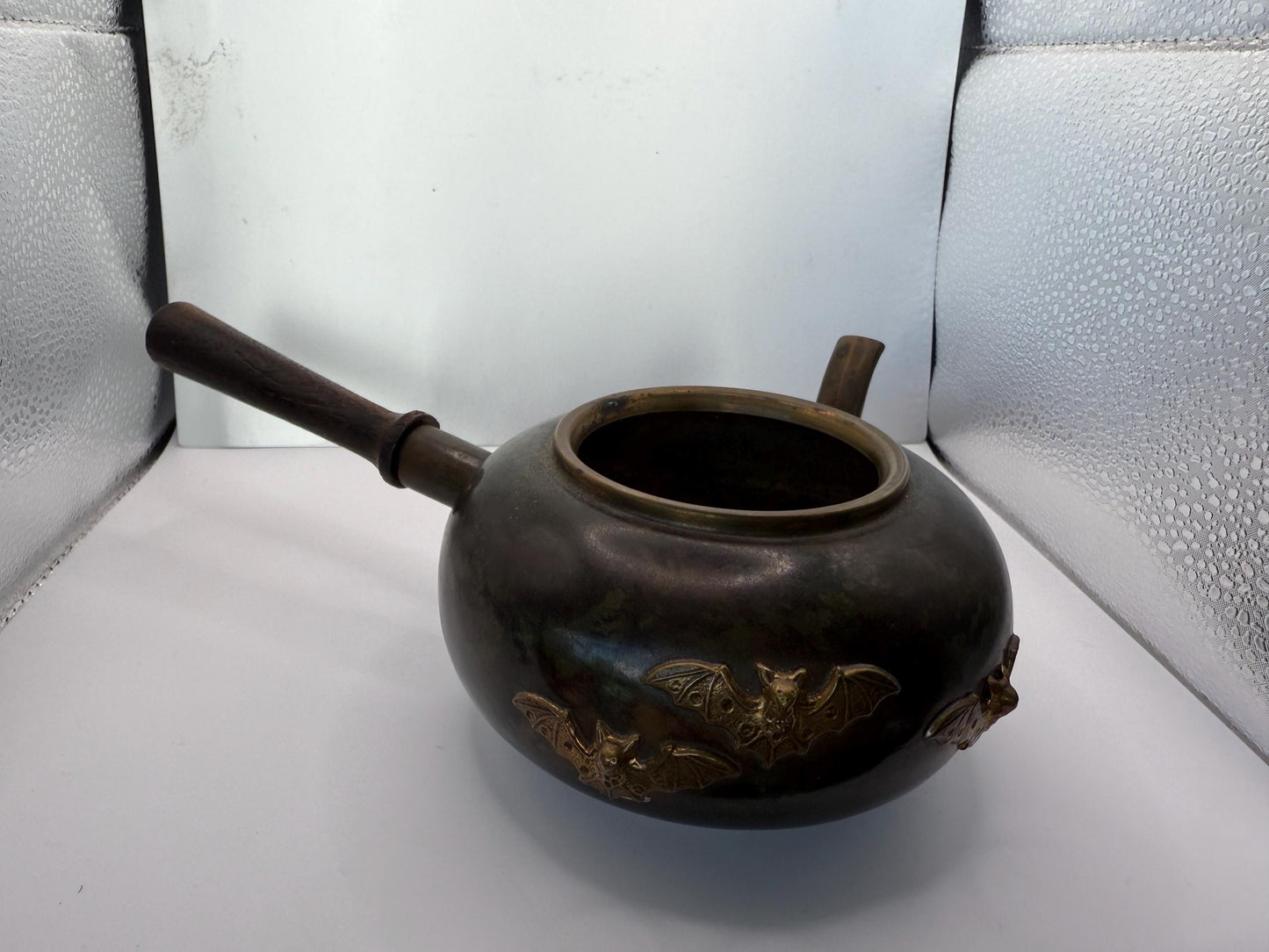 A cooper bronze vintage tea kettle with bats and moons wooden handle