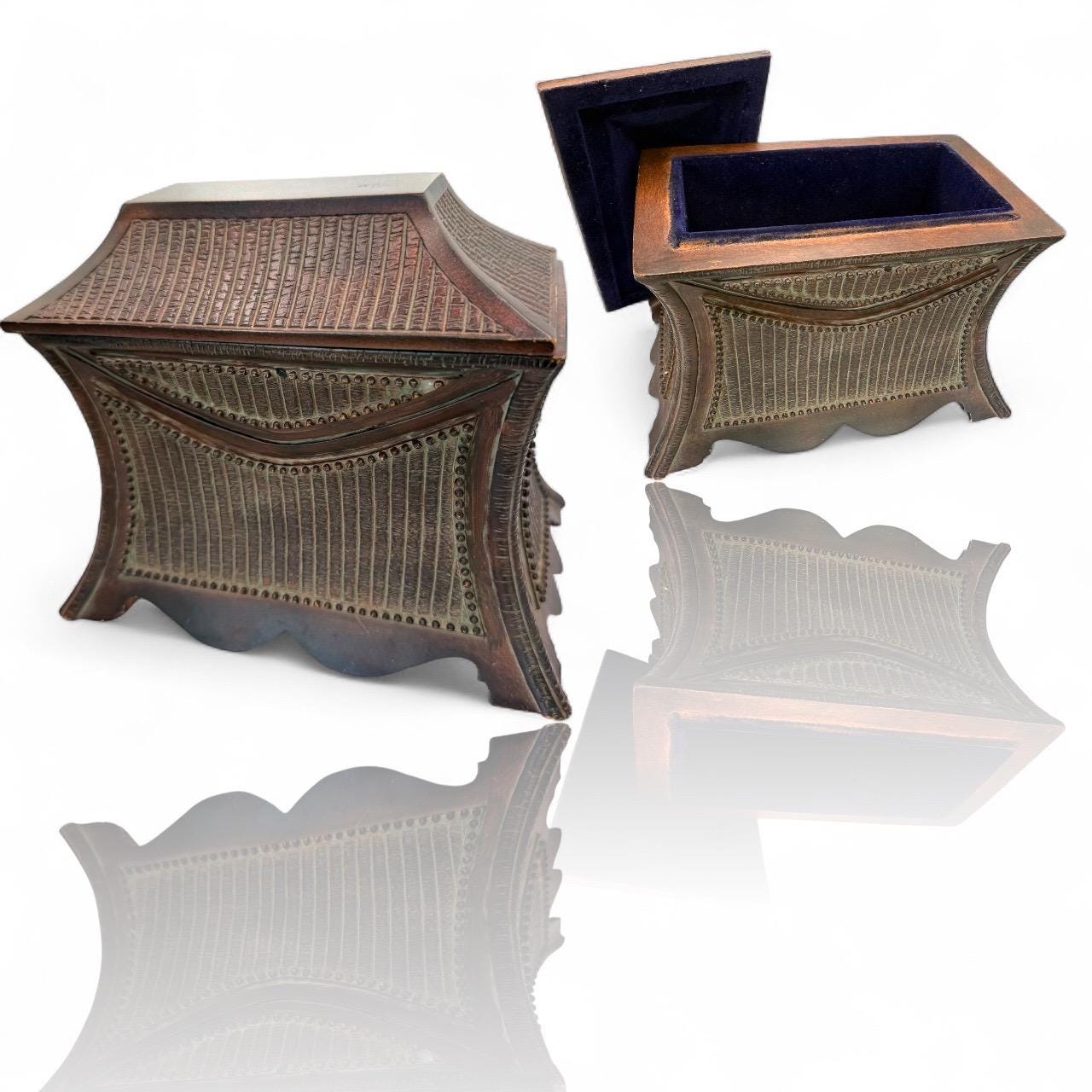 A vintage wooden oriental style jewelry box with suede lined inside interior