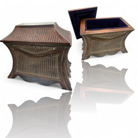 A vintage wooden oriental style jewelry box with suede lined inside interior