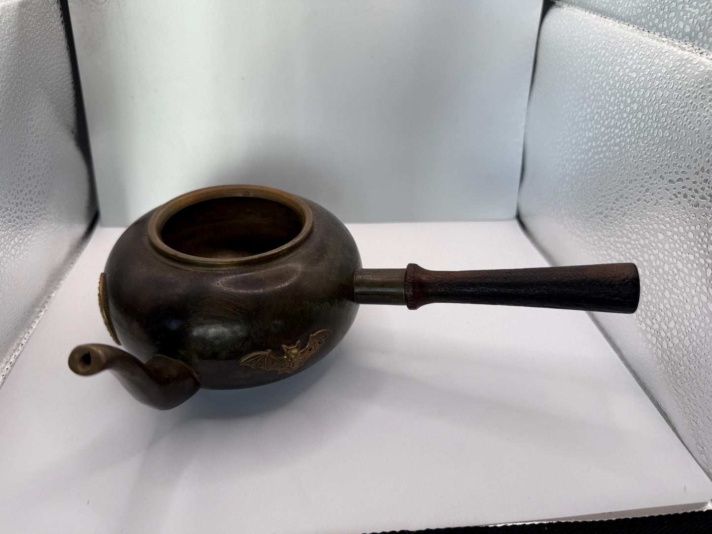 A cooper bronze vintage tea kettle with bats and moons wooden handle