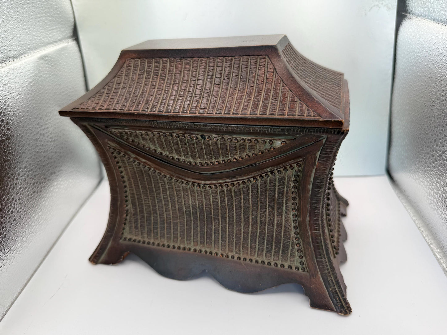A vintage wooden oriental style jewelry box with suede lined inside interior