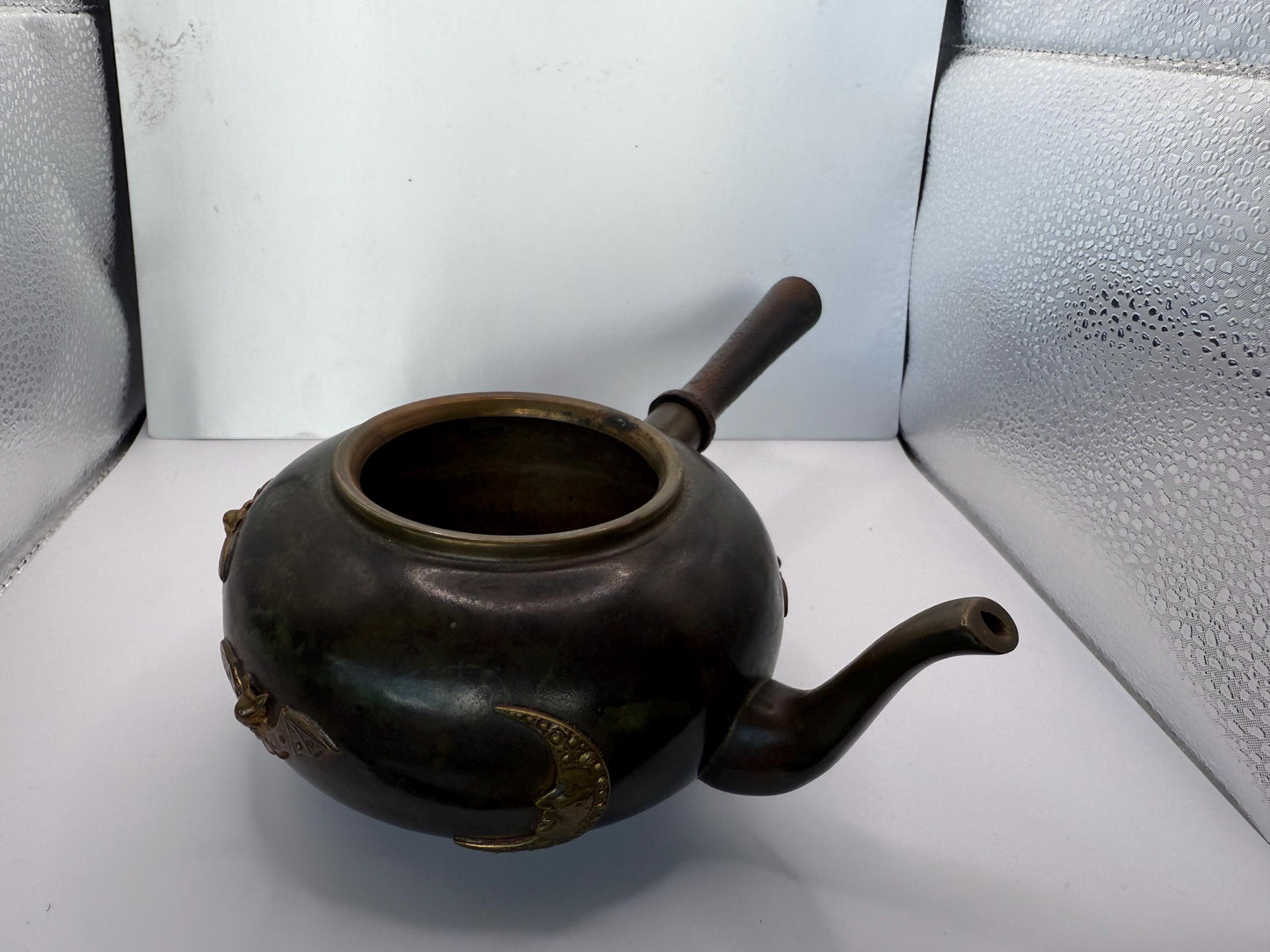 A cooper bronze vintage tea kettle with bats and moons wooden handle