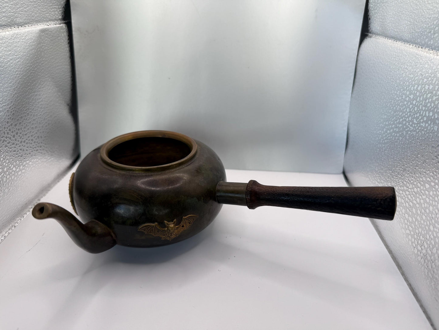 A cooper bronze vintage tea kettle with bats and moons wooden handle