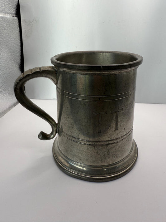A vintage solid pewter pint cup with handle 19th century American mug