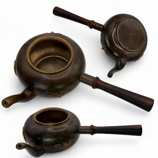 A cooper bronze vintage tea kettle with bats and moons wooden handle